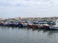 Colorful boats docked along the blue waters of Morocco’s Atlantic coast.