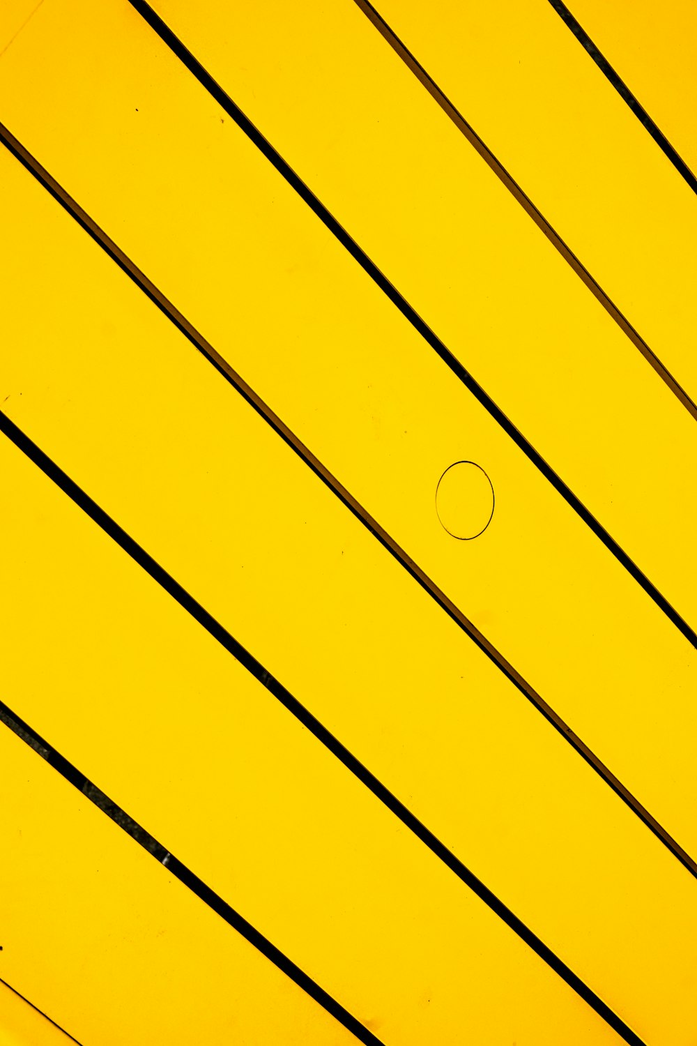 a close up of a telephone pole with a yellow background