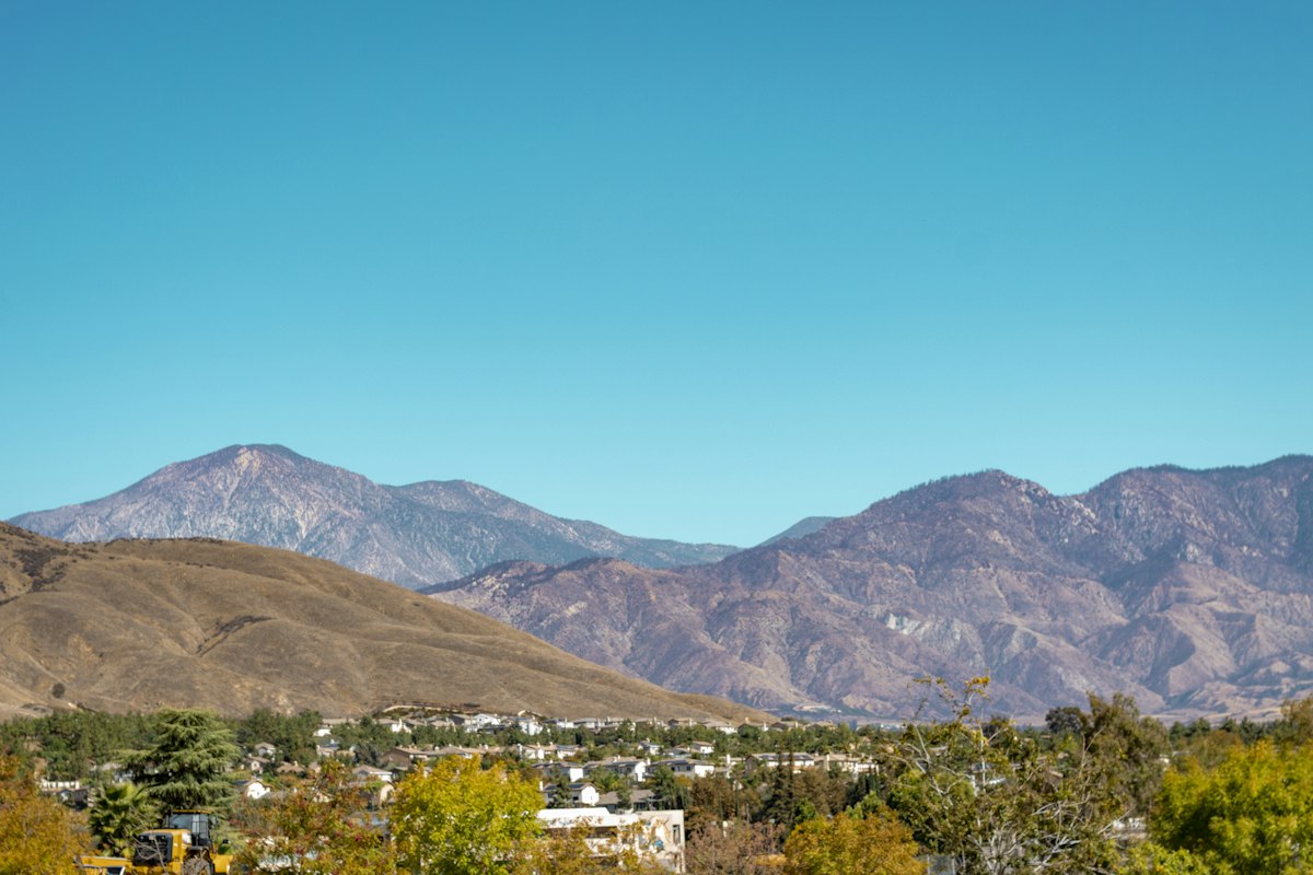 A town and homes with layered mountains in the background
