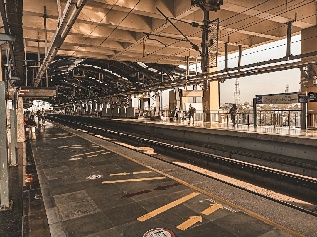 a train station with people waiting for the train,