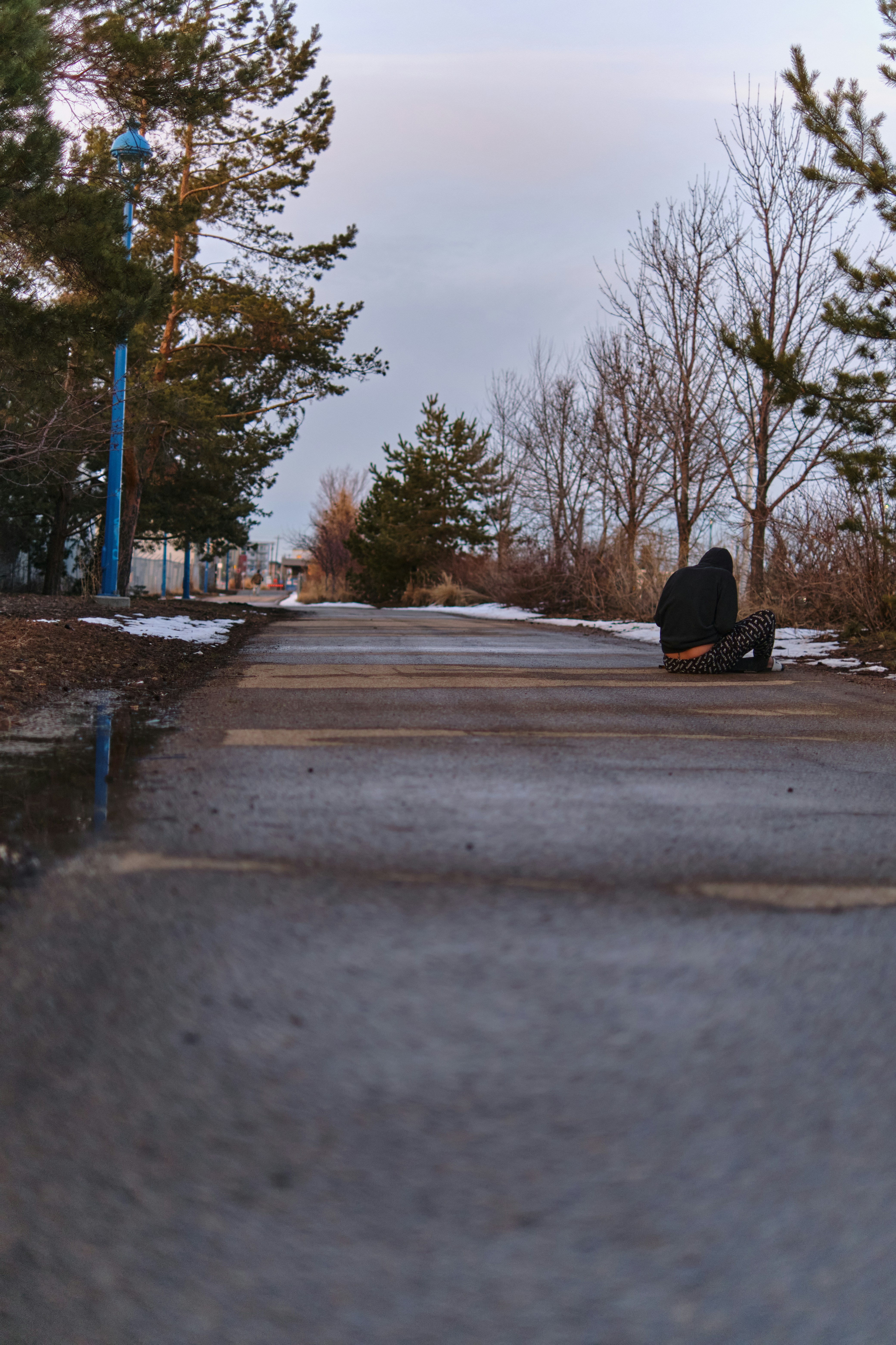 a black suitcase sitting on the side of a road