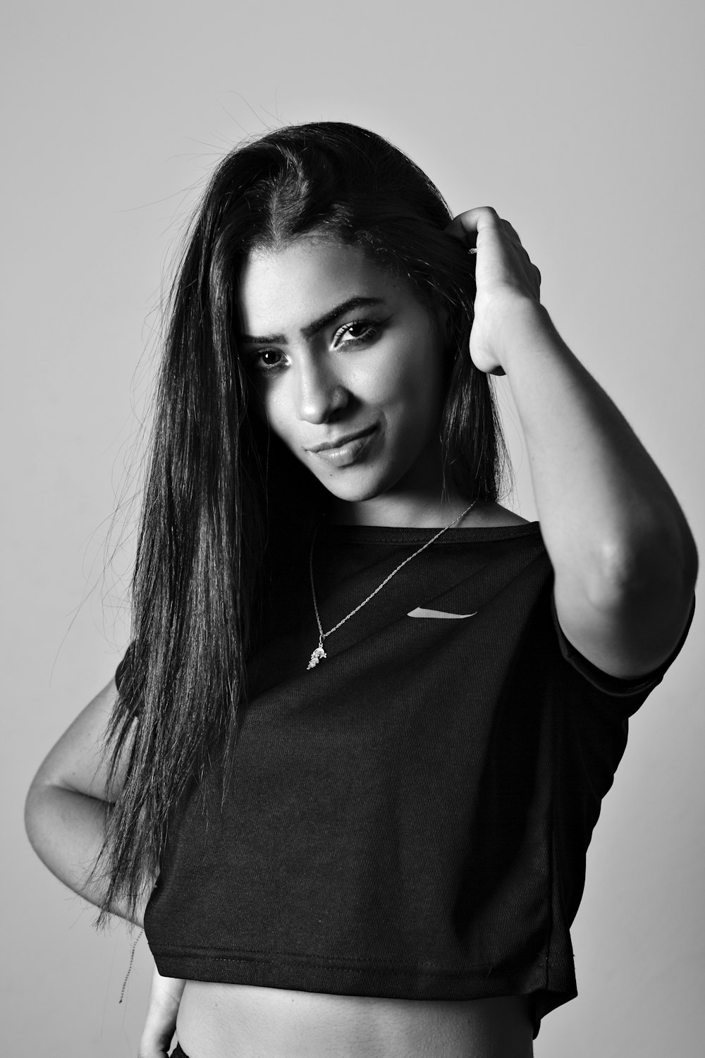 a black and white photo of a woman with long hair