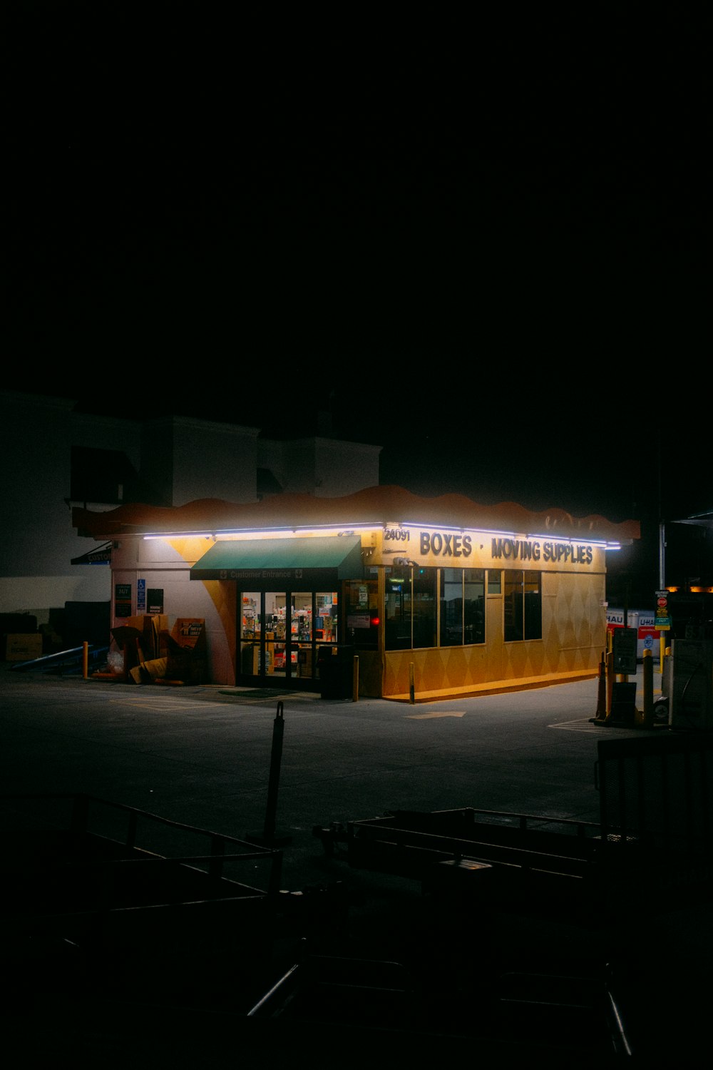 a gas station at night with the lights on