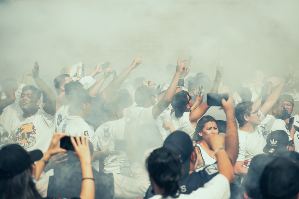 a crowd of people standing around each other