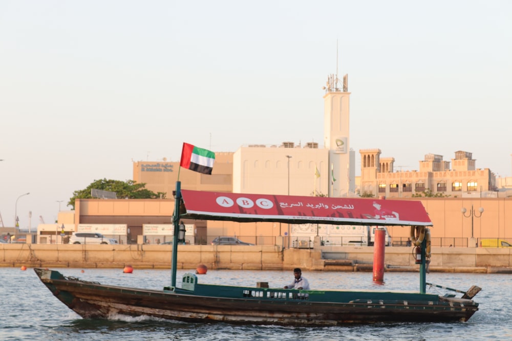 a small boat with a flag on it in the water