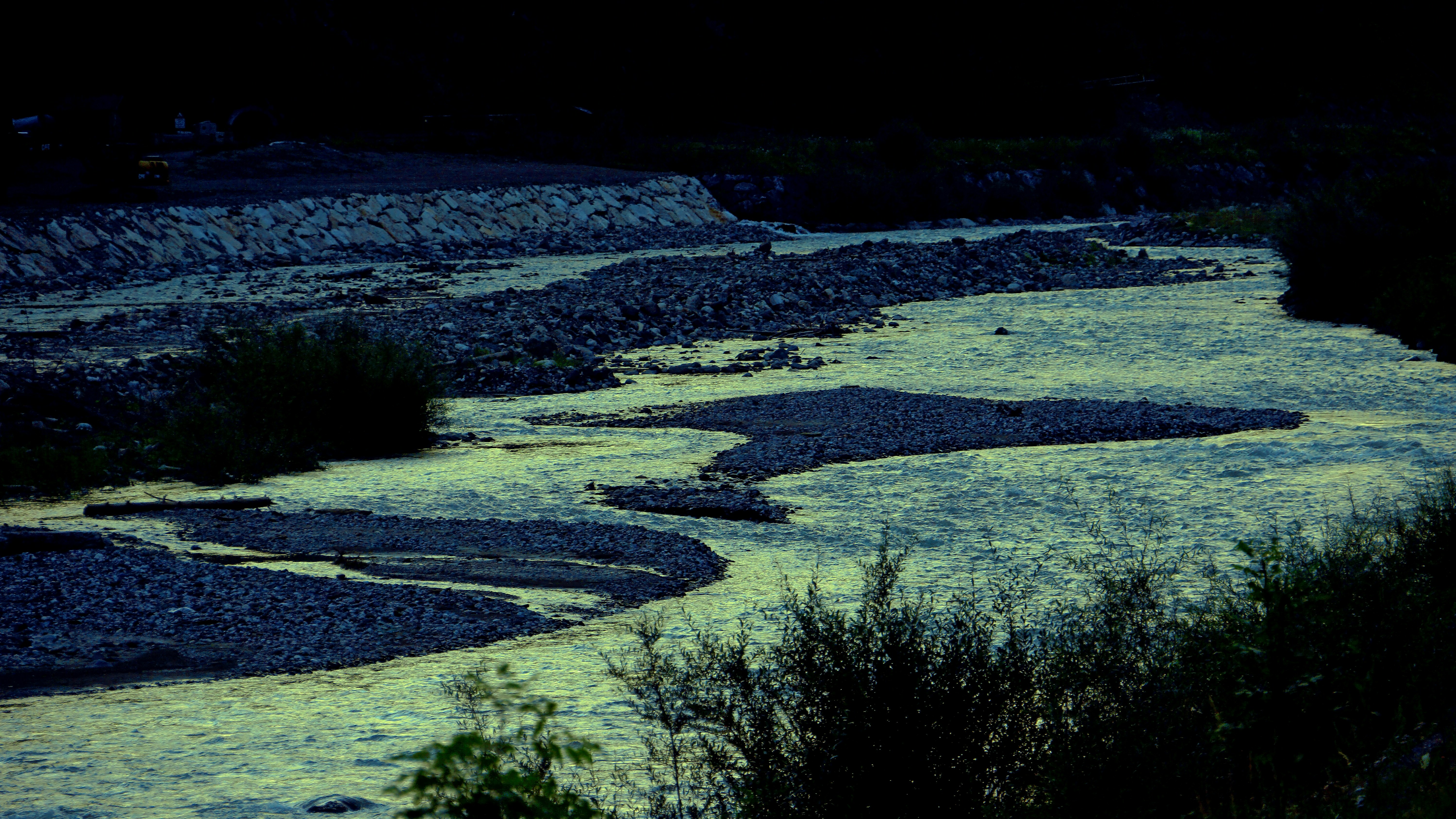 a river running through a lush green forest