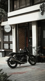 Mobile coffee motorcycle parked outside a modern office building serving fresh coffee.
