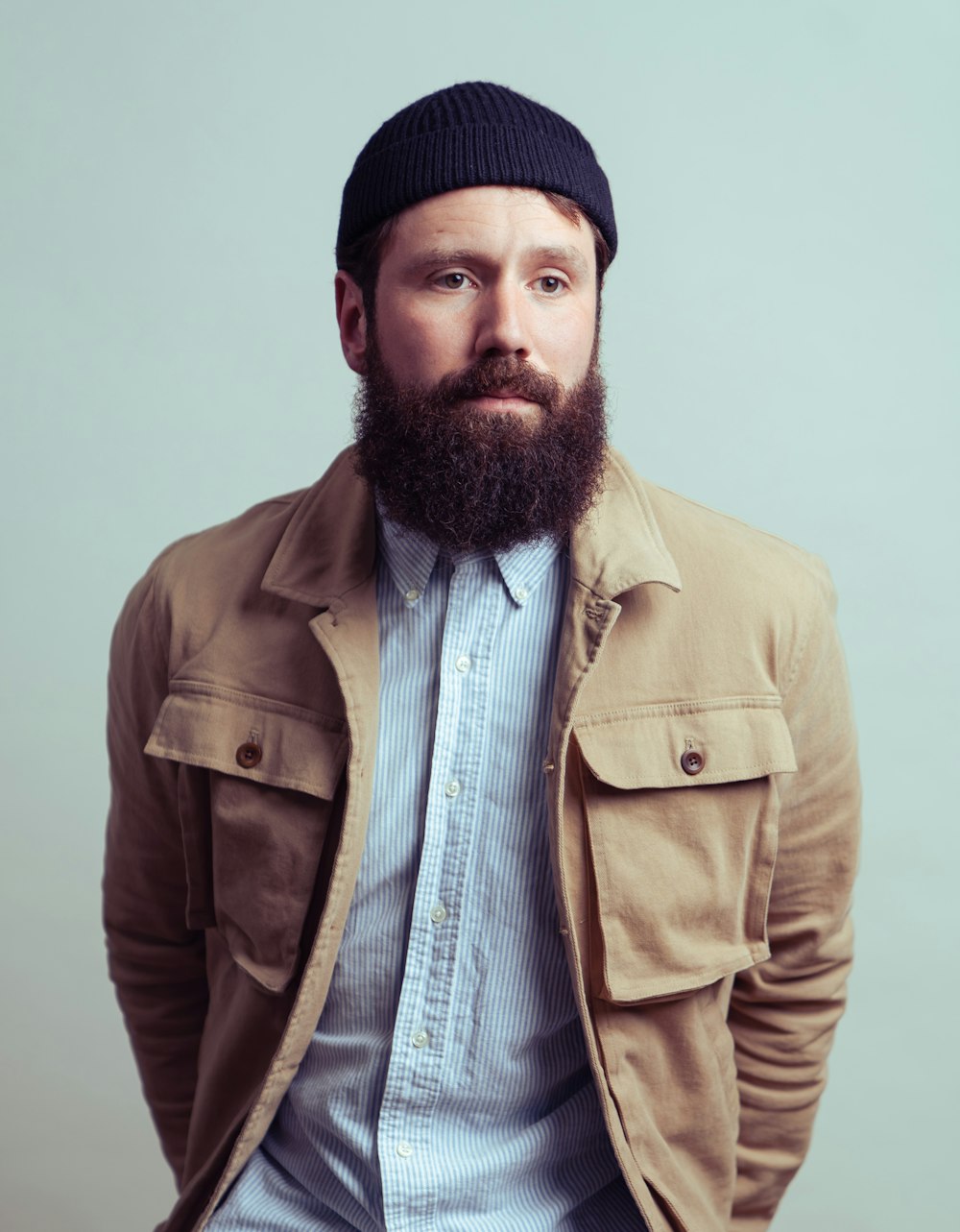 a man with a beard wearing a hat