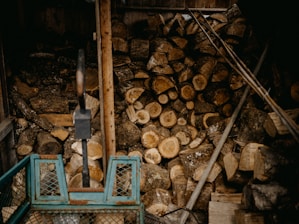 a pile of wood sitting next to a pile of logs