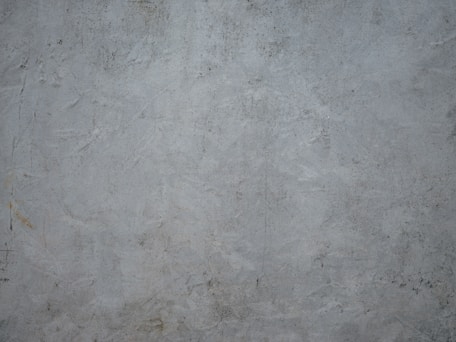 a white wall with a red fire hydrant on it