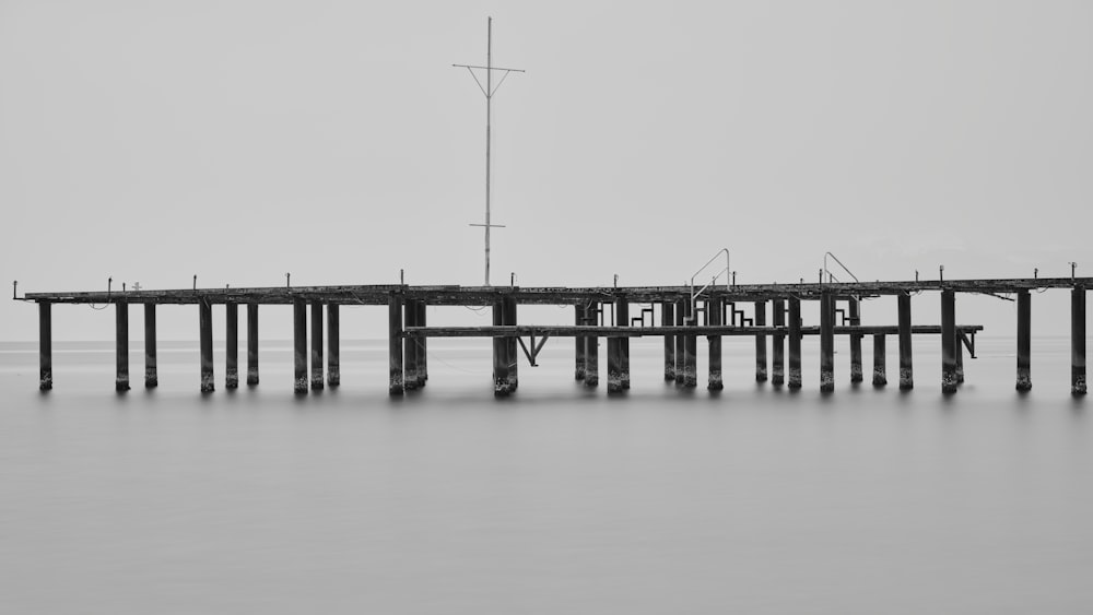 a black and white photo of a pier