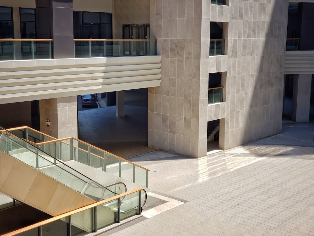 a building with a staircase and a car parked in front of it