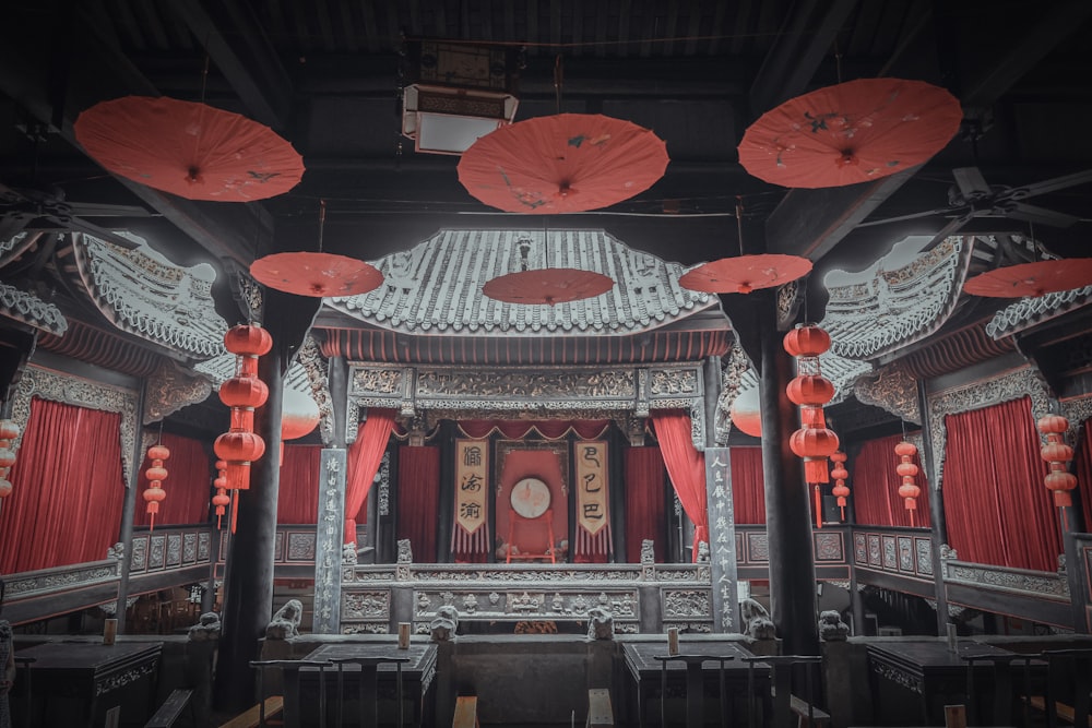 a building with red lanterns hanging from it's ceiling