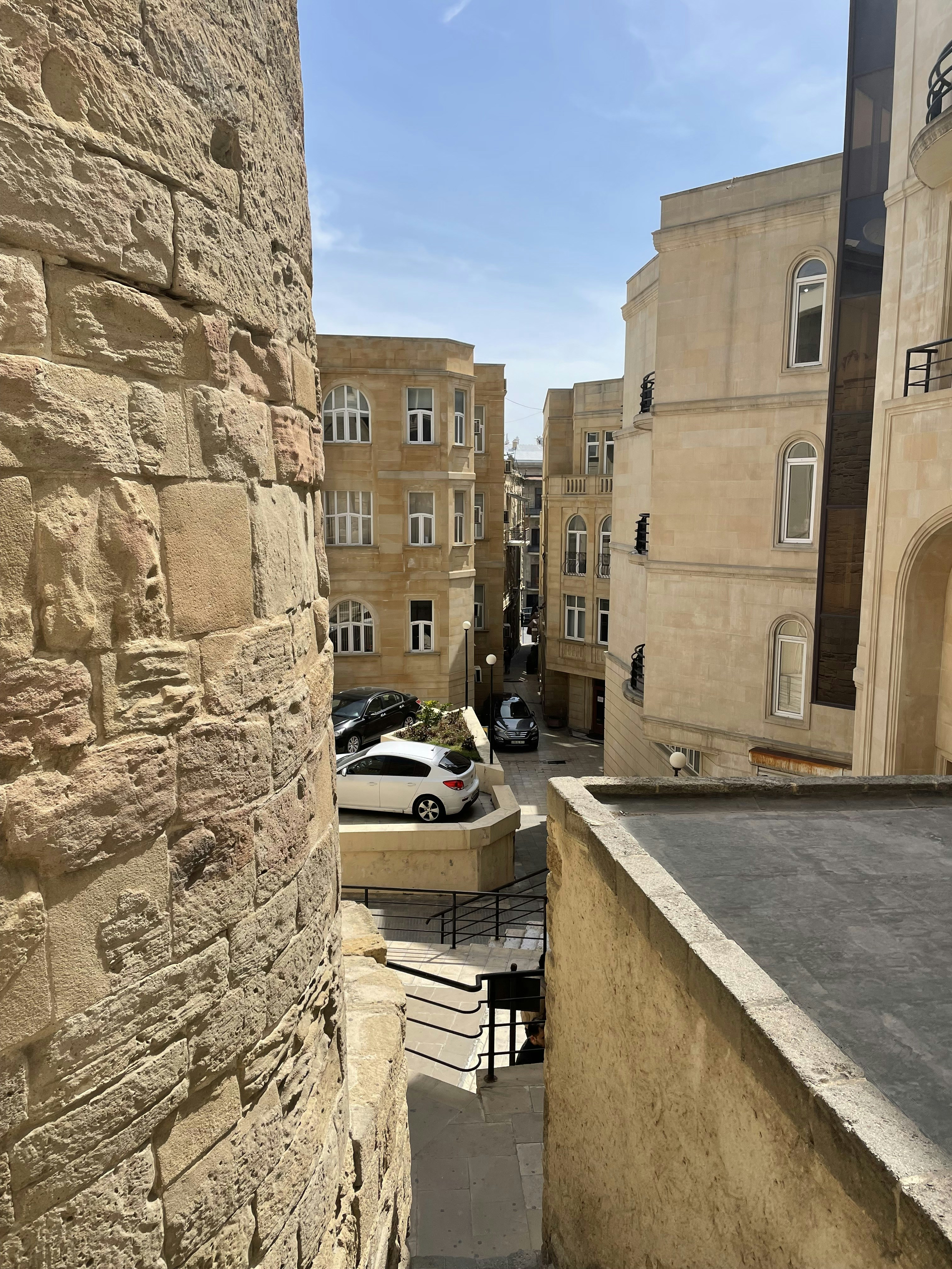 a view of a street with cars parked on the side of it