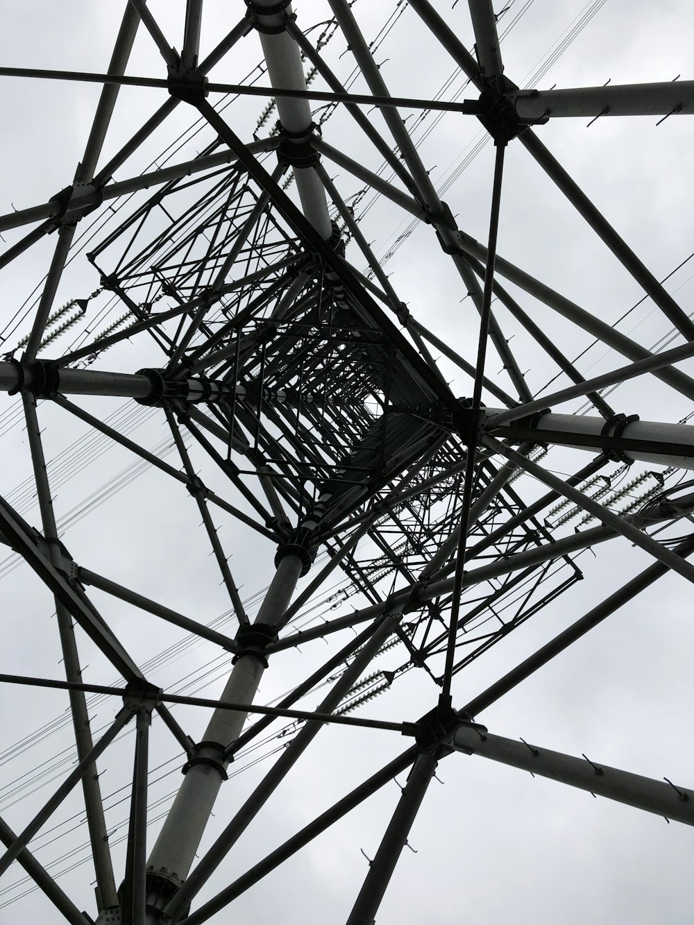 a tall metal structure with lots of wires on top of it