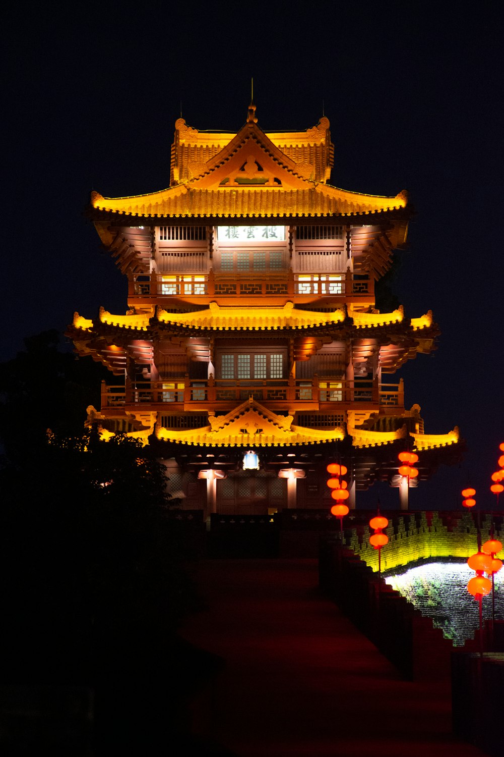 a tall building lit up at night with lights