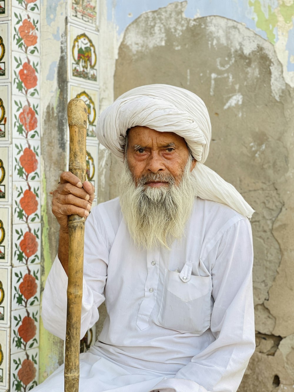 a man with a long white beard holding a stick