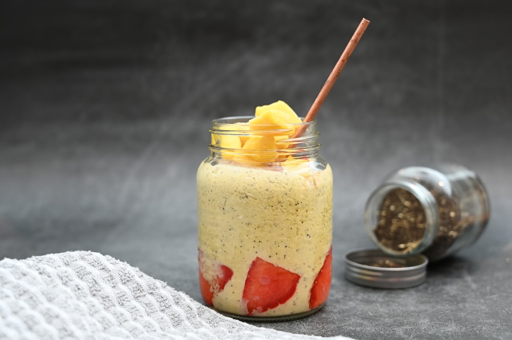 a jar of food with a straw sticking out of it