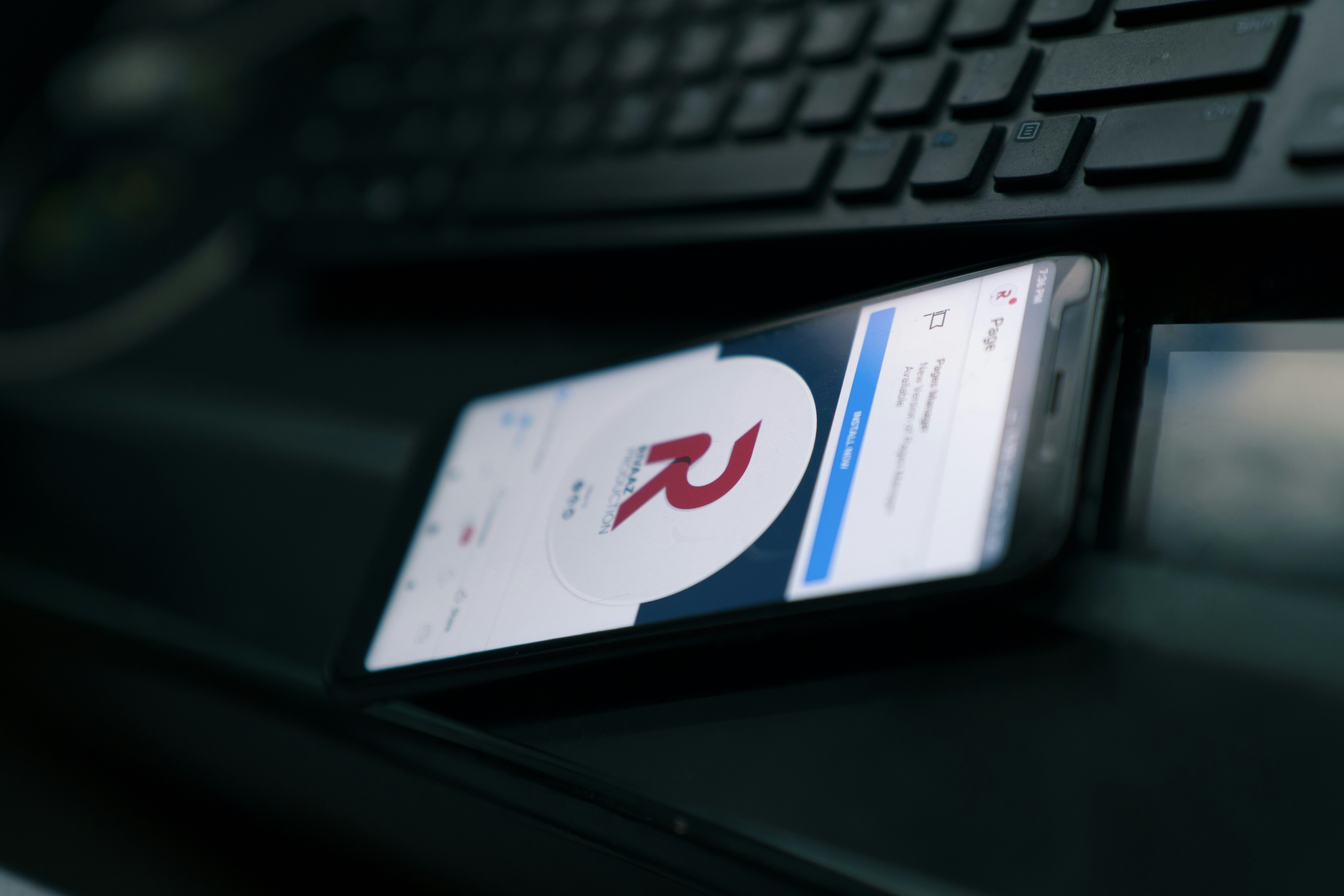 a close up of a cell phone near a keyboard