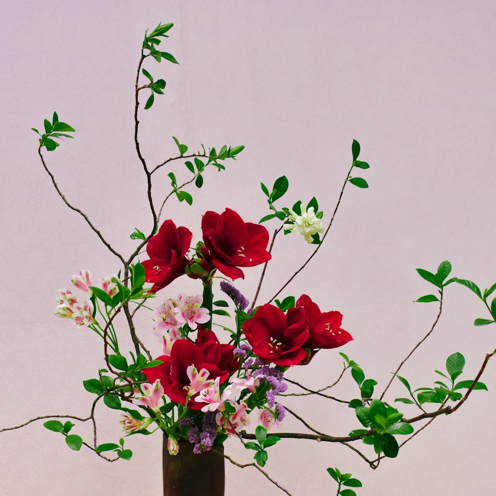 a vase filled with lots of flowers on top of a table