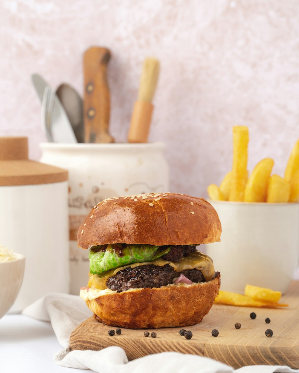 a hamburger sitting on top of a wooden cutting board