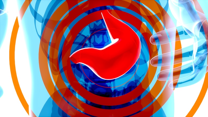 A stylized, abstract representation of a human stomach in bright red against a backdrop of circular blue and orange radiating patterns. The composition includes outlines of human hands in a blue hue, suggesting a gesture or focus towards the stomach.