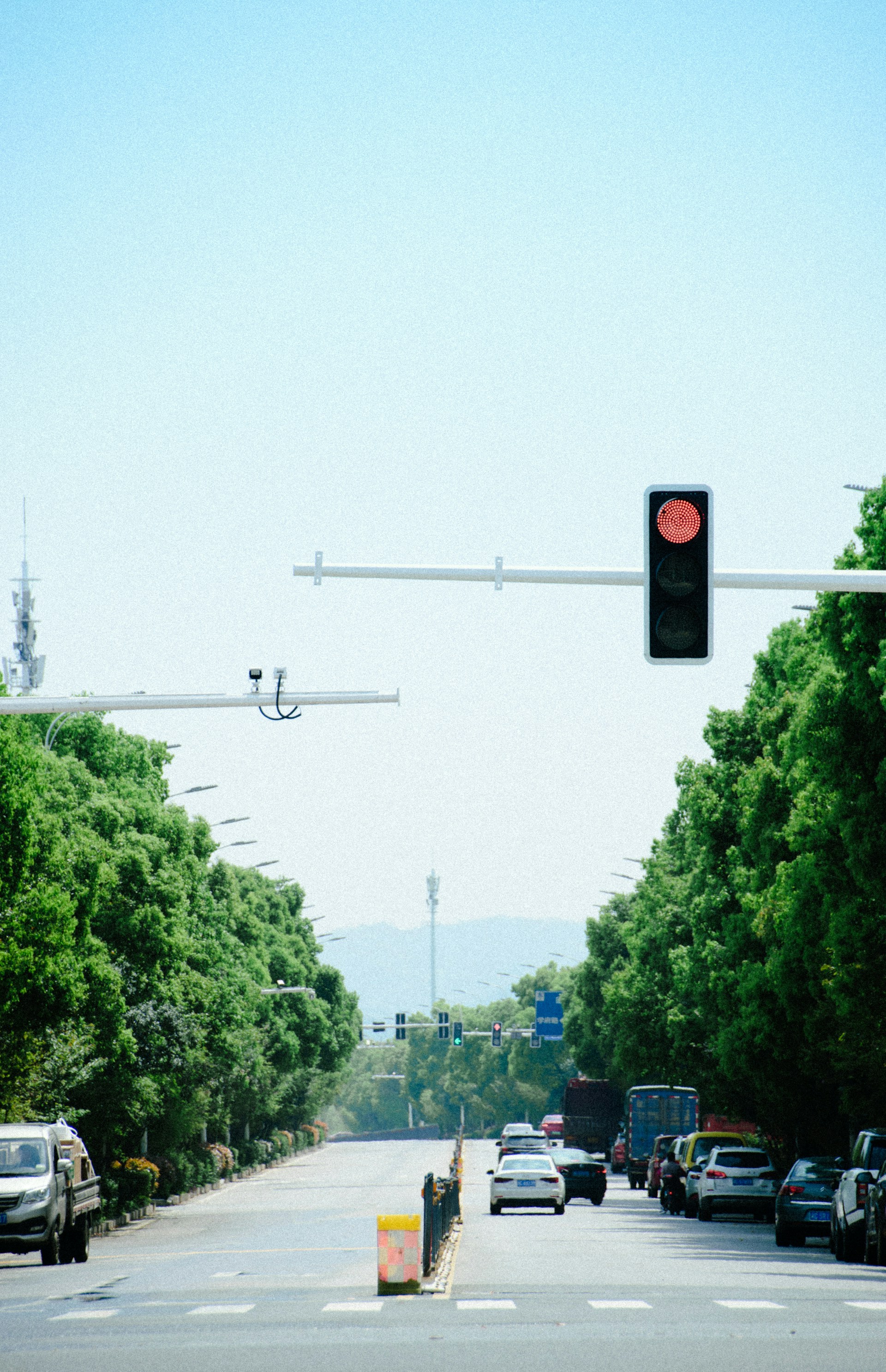 a traffic light hanging over a street filled with traffic