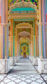 a colorful building with columns and a tiled floor