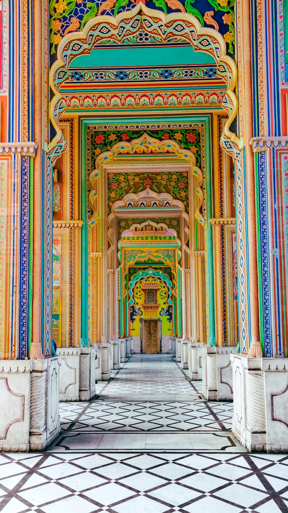 a colorful building with columns and a tiled floor