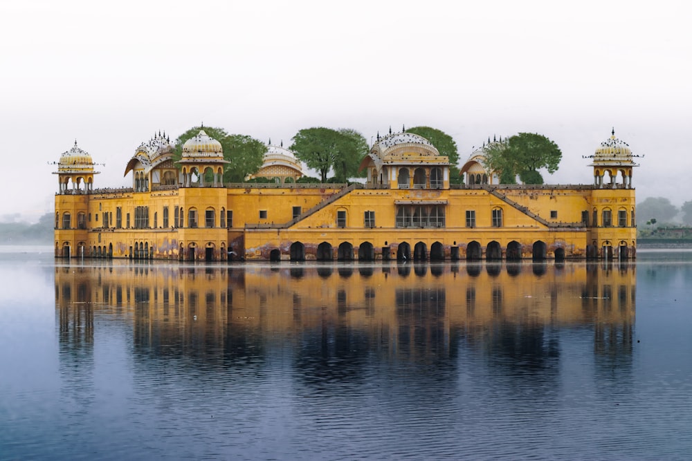 a large yellow building sitting on top of a lake