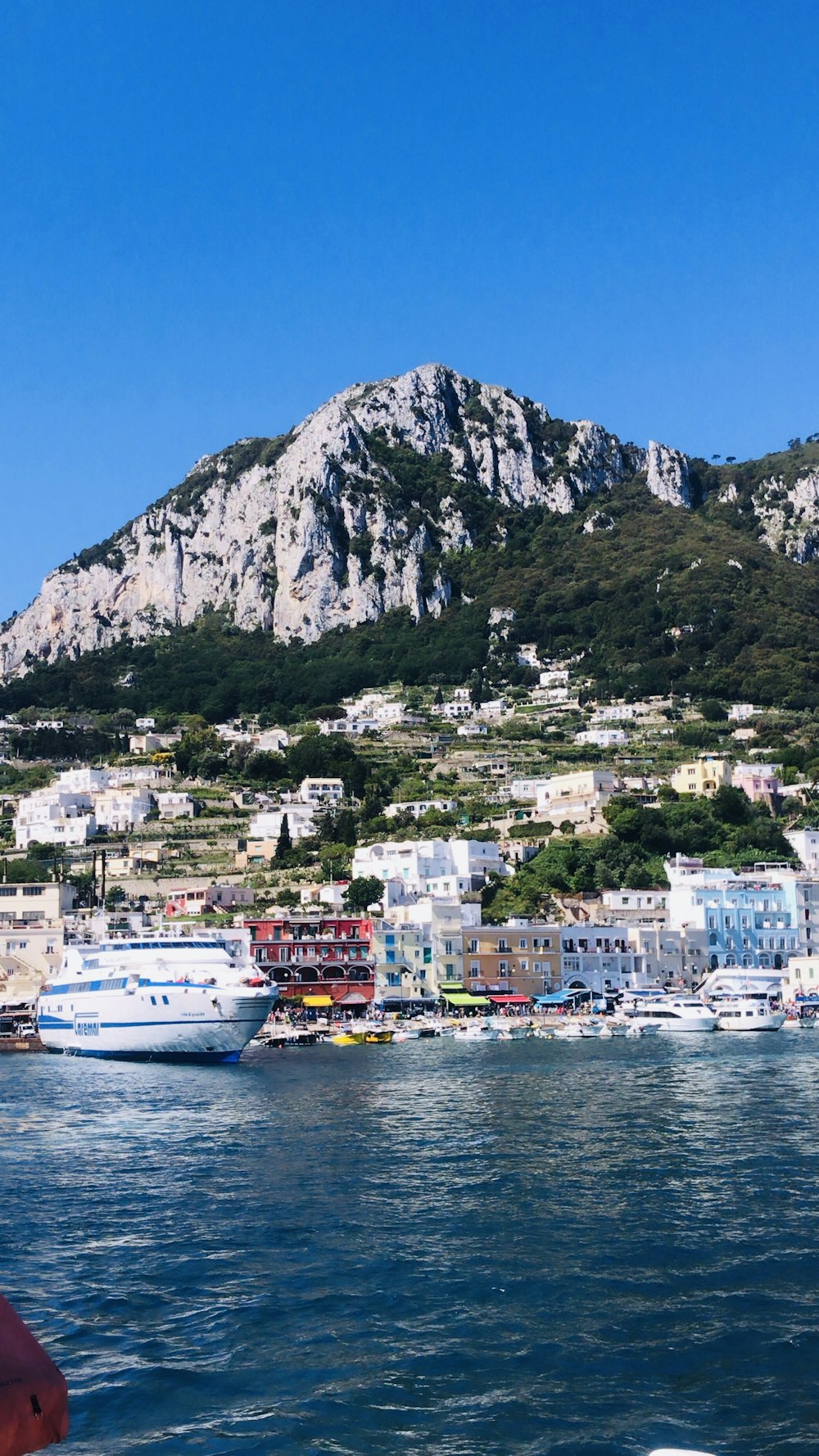 a large body of water with a mountain in the background