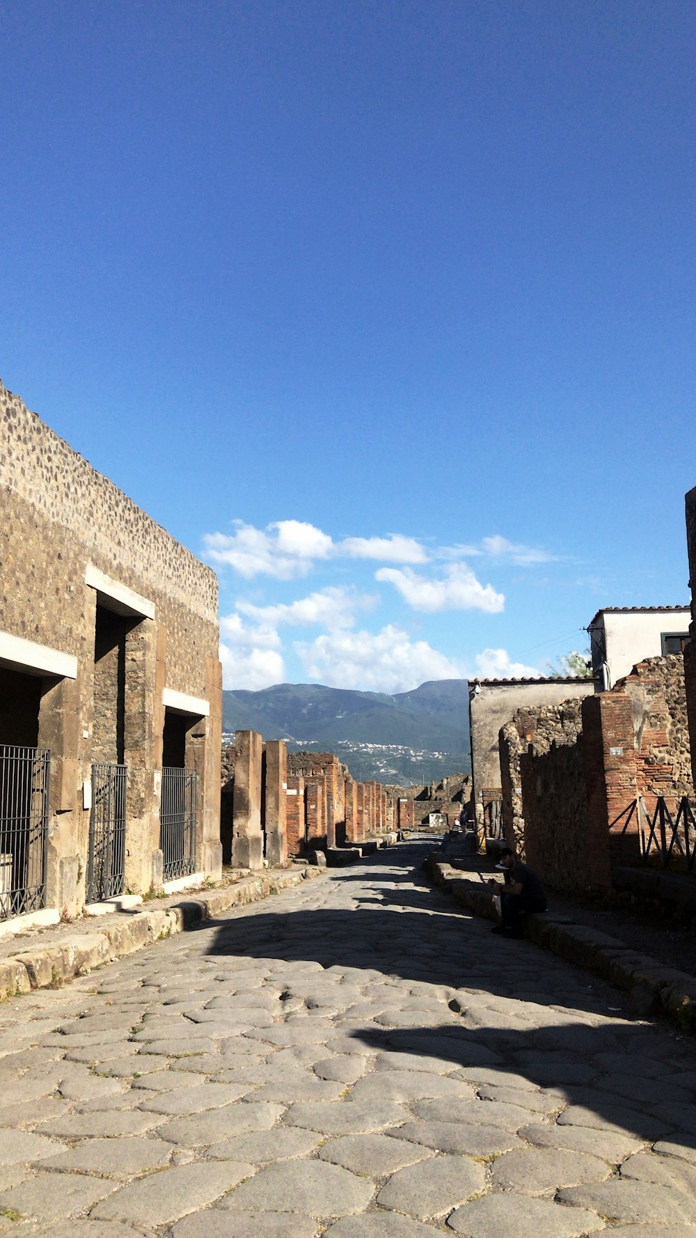 a cobblestone street lined with stone buildings