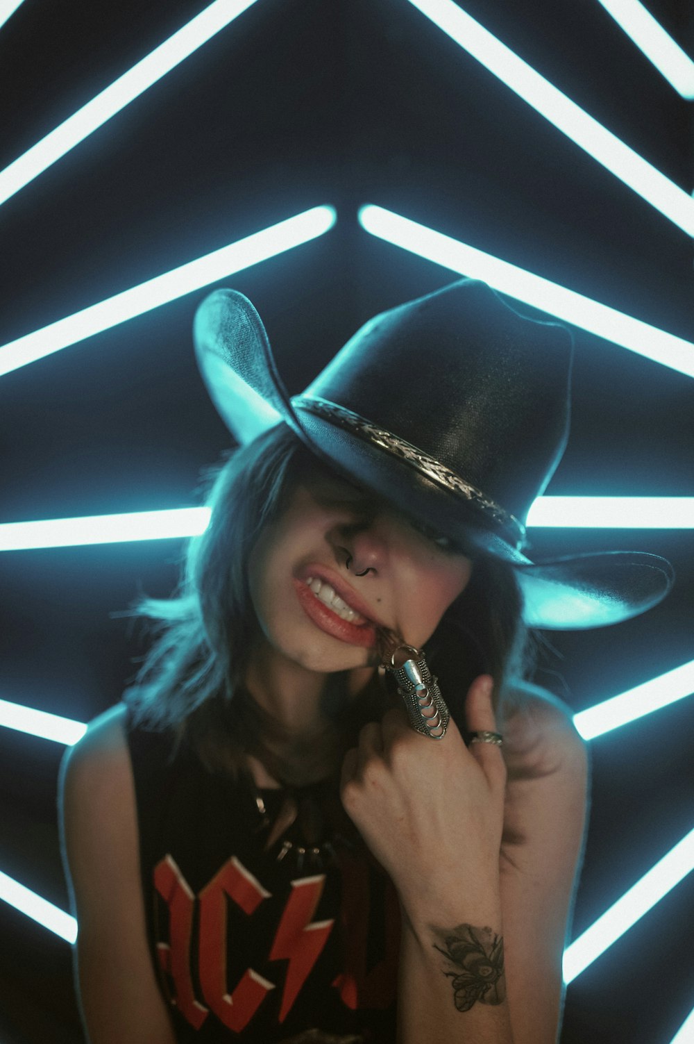 a woman wearing a cowboy hat talking on a cell phone