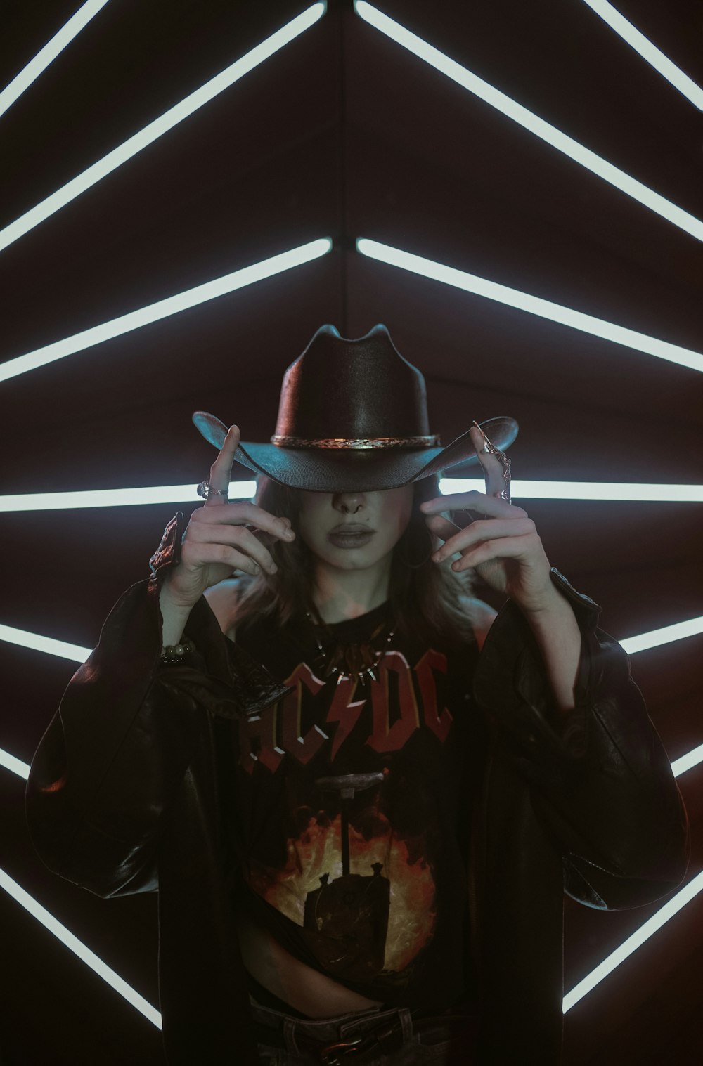 a woman wearing a cowboy hat and holding a gun