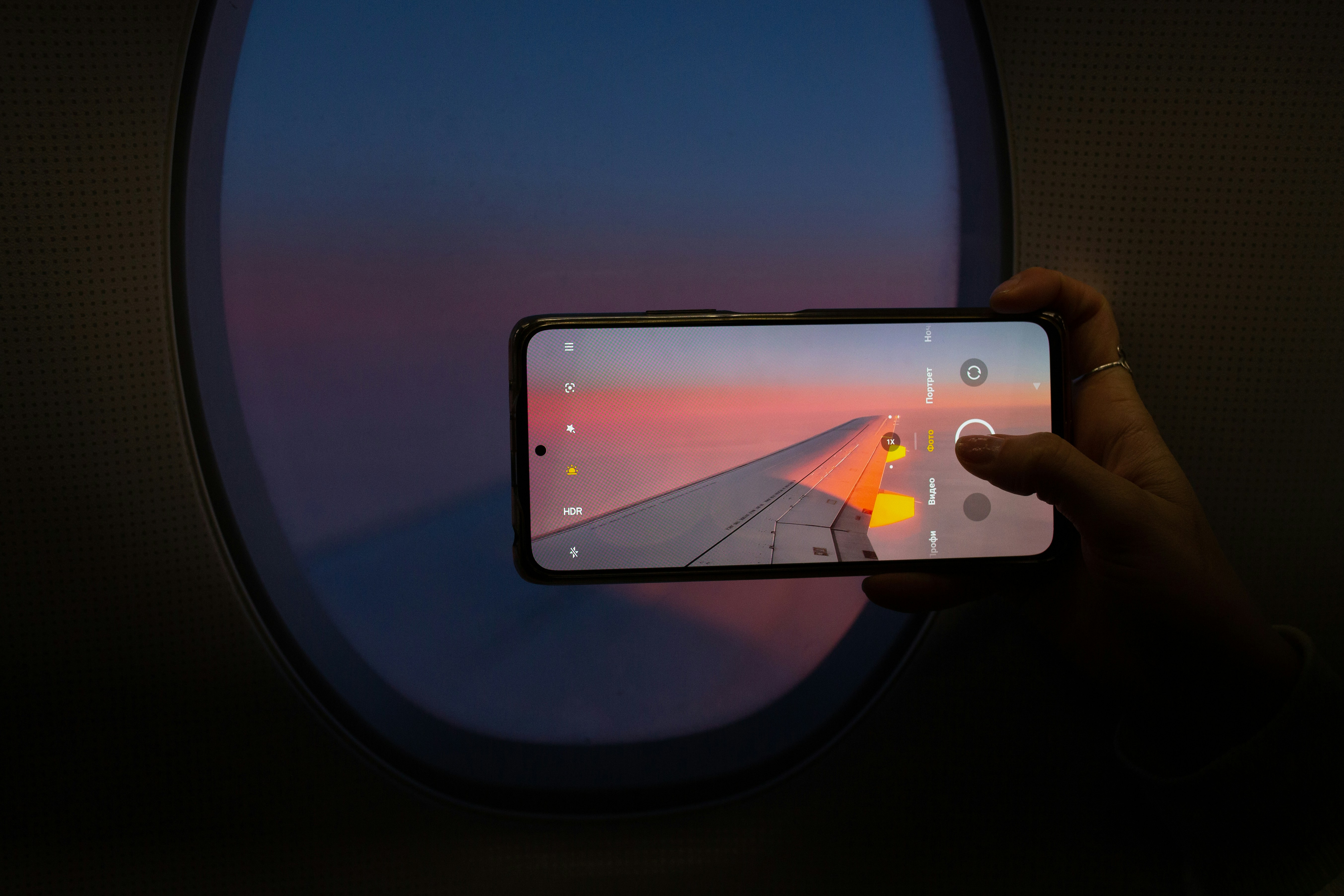 Person taking photo of airplane wing
