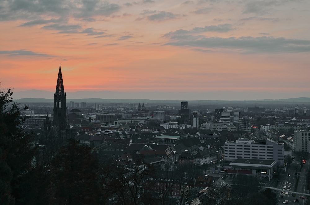 a view of a city at sunset from a hill