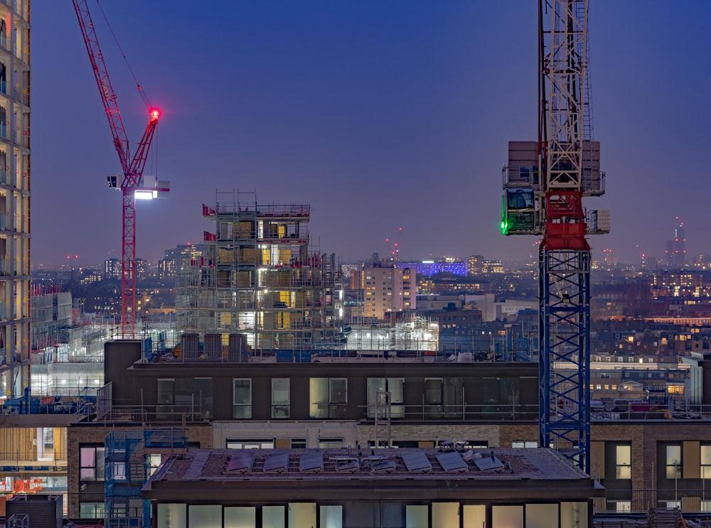 a view of a city at night with a crane in the foreground