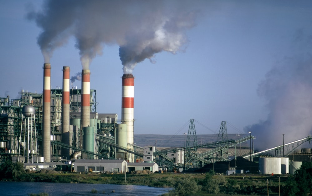 a factory with smoke coming out of it's stacks