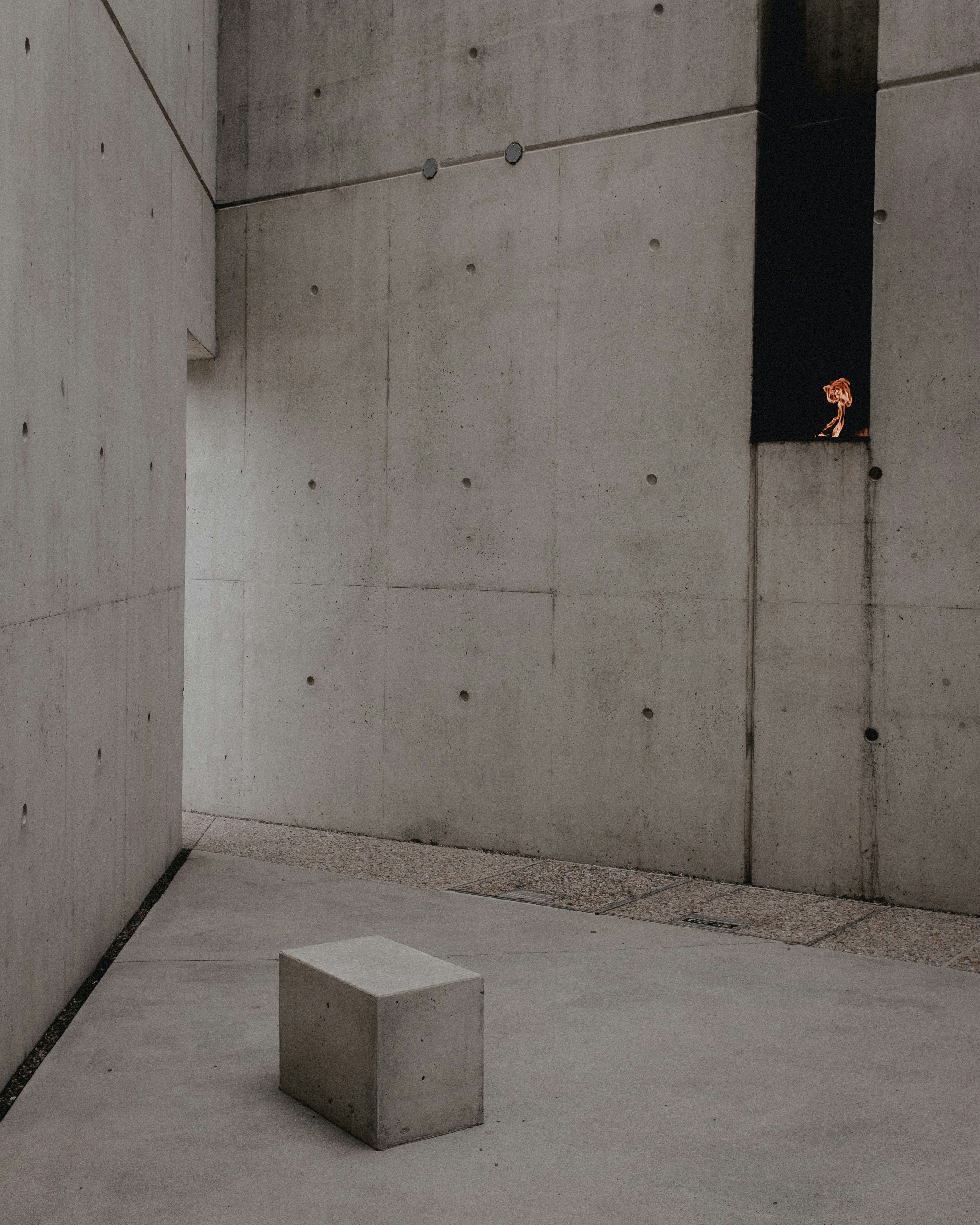 a concrete block sitting in a room next to a window