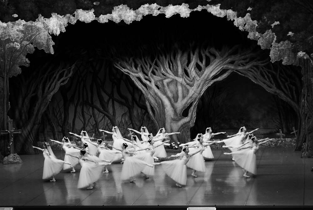 a group of ballerinas are dancing on a stage