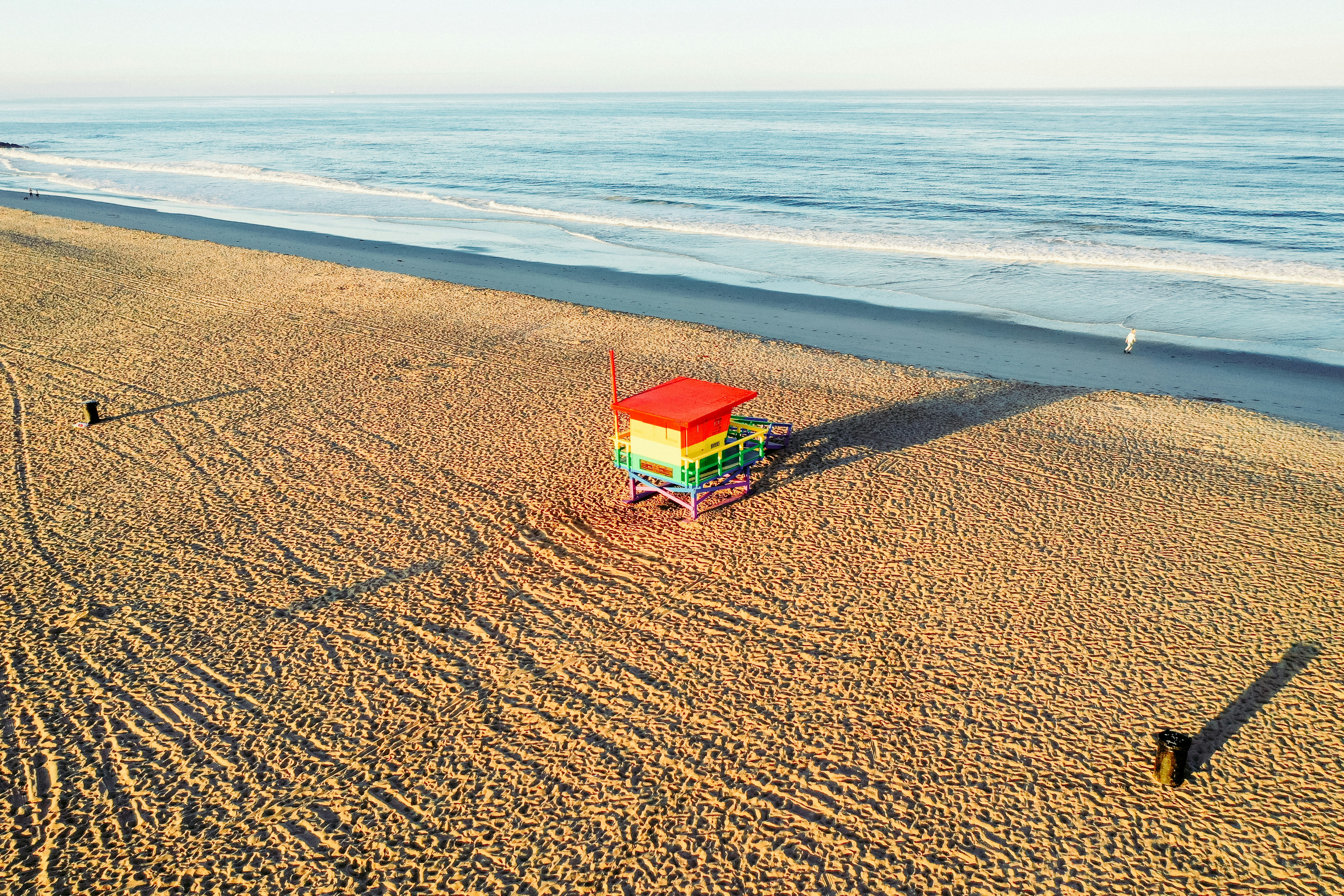 a lifeguard tower on a beach next to the ocean