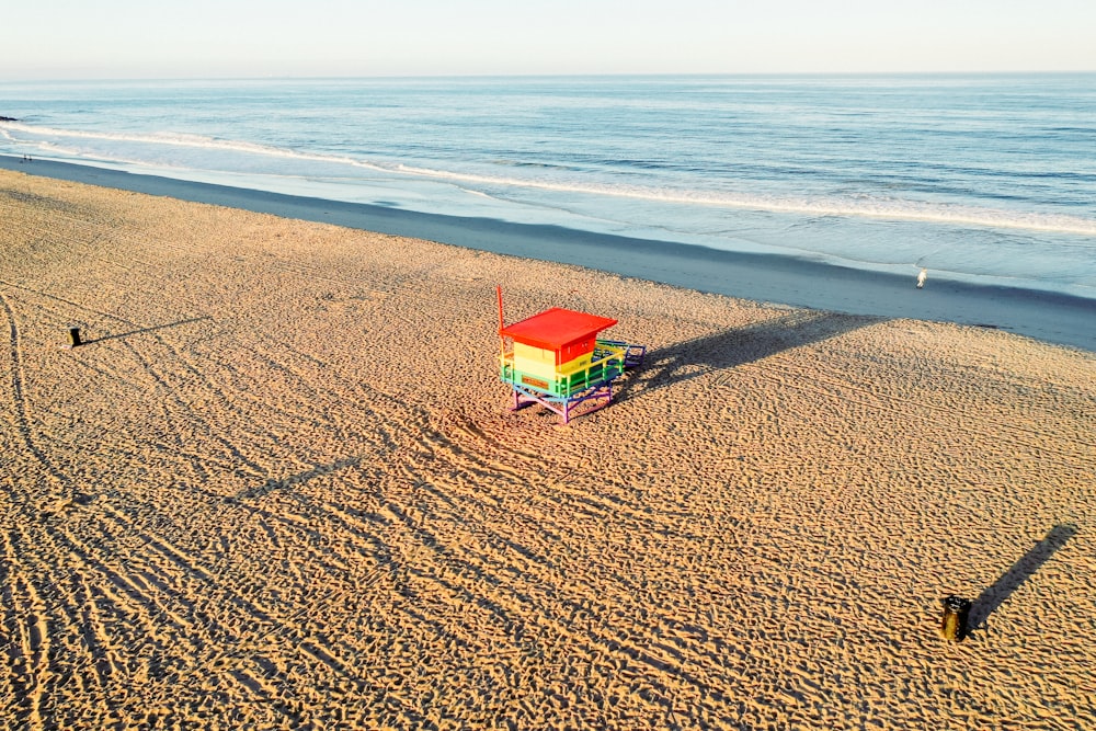 a lifeguard tower on a beach next to the ocean