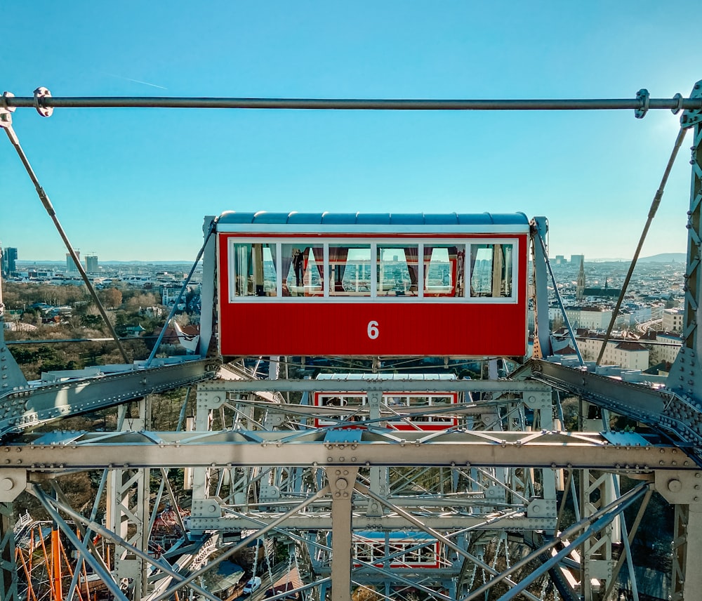 a red and blue train going over a bridge