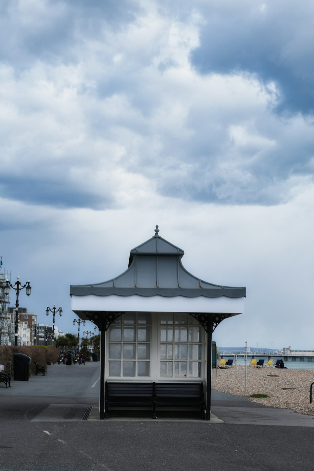 a white and black shelter sitting on top of a sandy beach