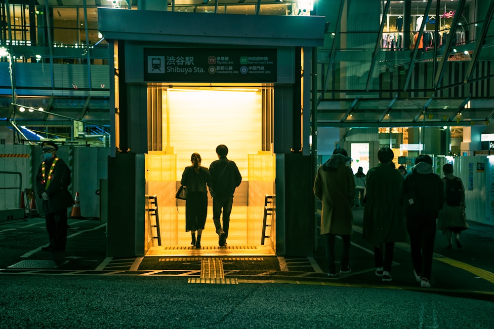 a group of people standing outside of a building