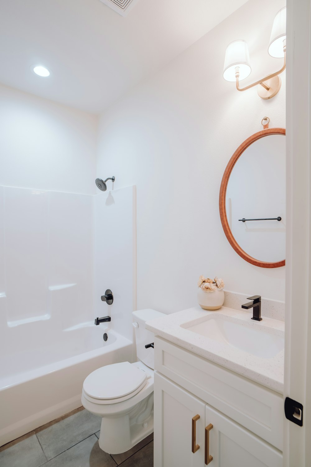 a bathroom with a toilet, sink, and bathtub