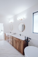 a bathroom with two sinks and a bathtub