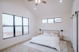 a bedroom with a bed and a ceiling fan