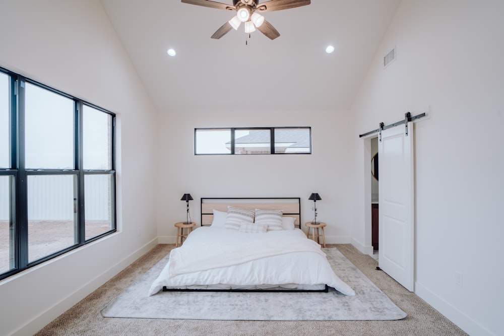 a bedroom with a bed and a ceiling fan