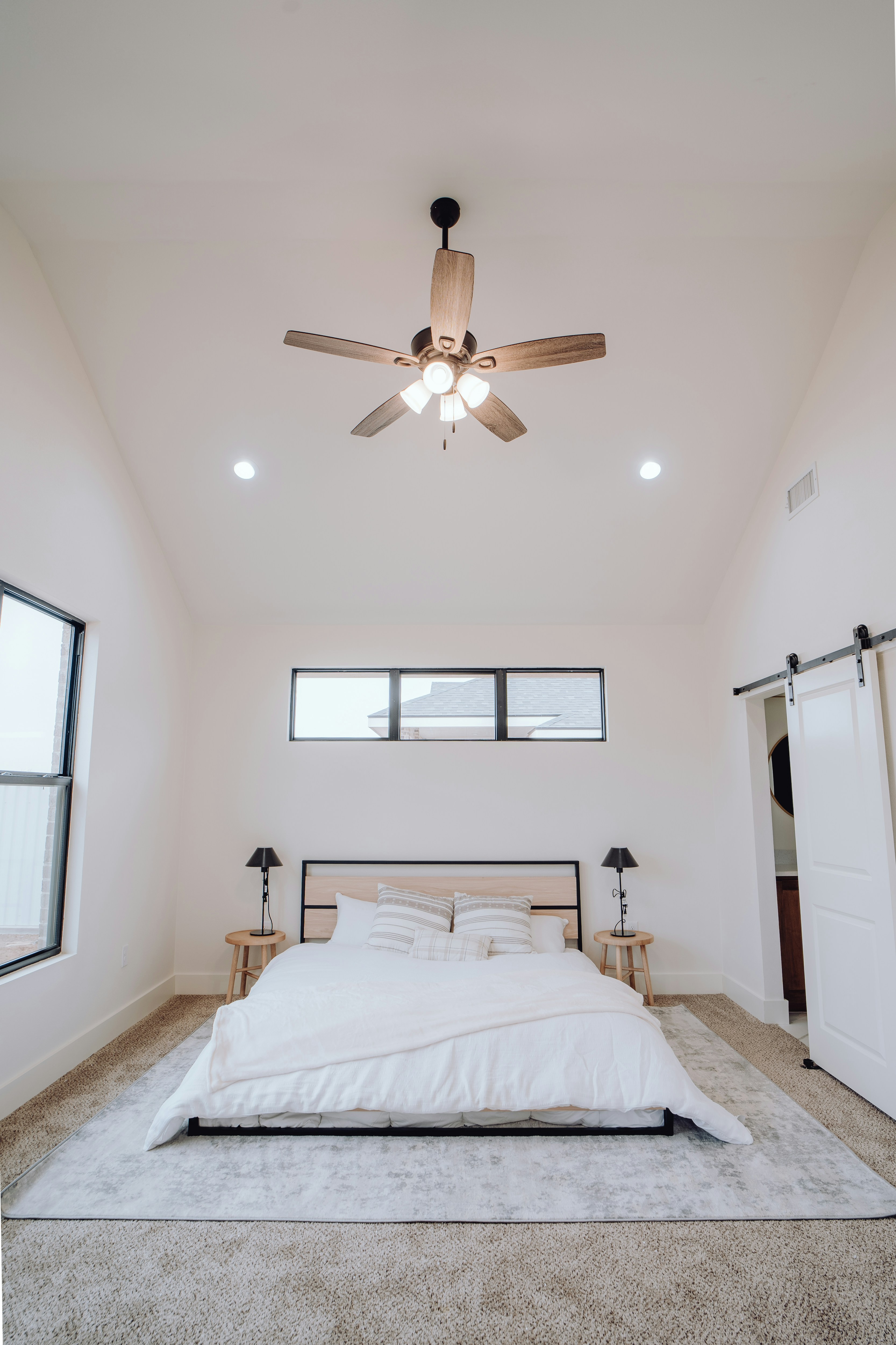 a bedroom with a bed and a ceiling fan